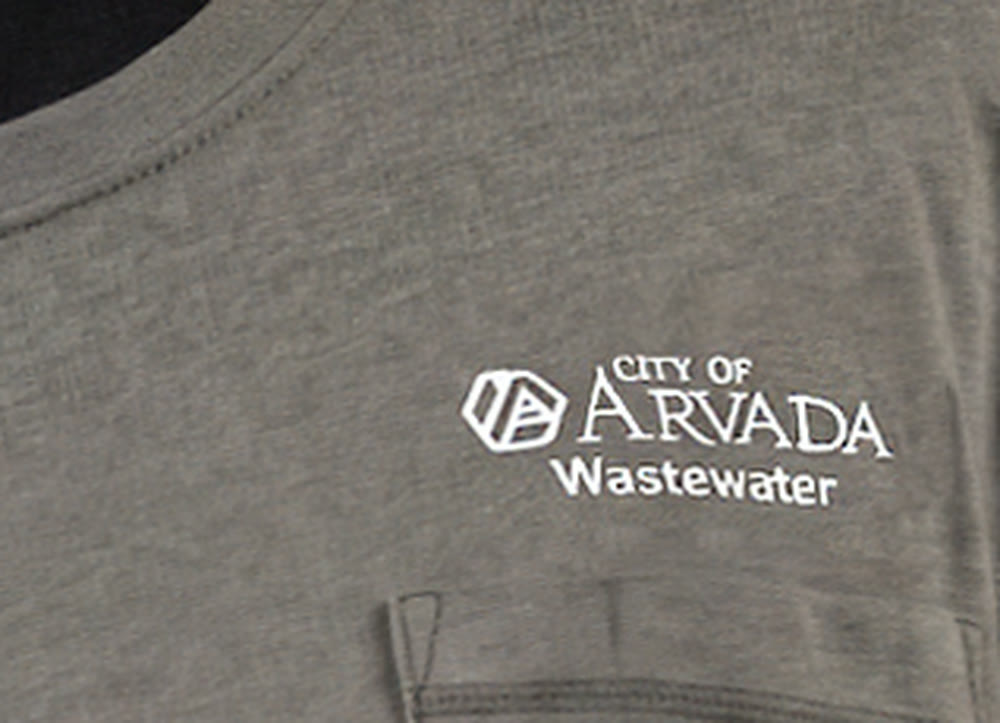Embroidered City of Arvada Wastewater logo on staff uniform