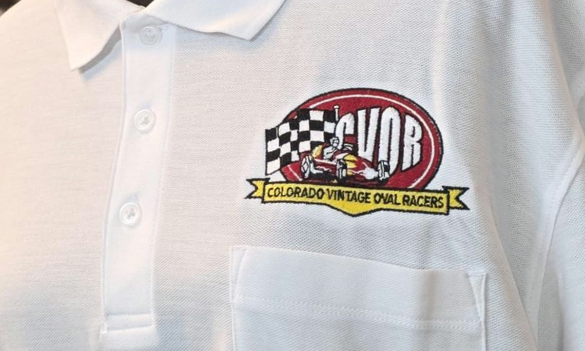 Embroidered Colorado Vintage Oval Racers logo on a white polo shirt