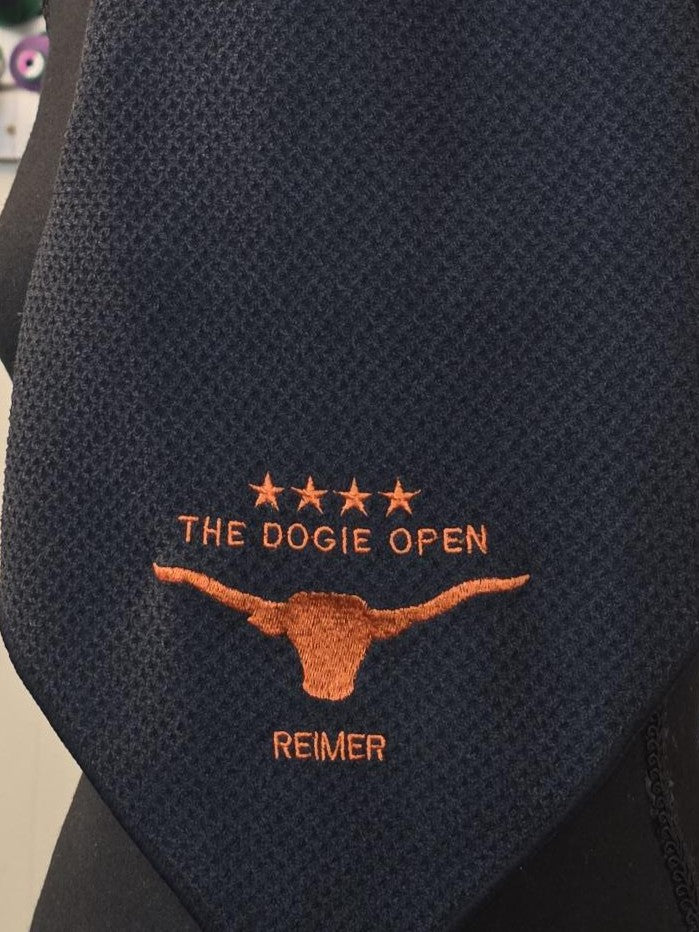 Embroidered tie for The Dogie Open golf tournament with longhorn logo